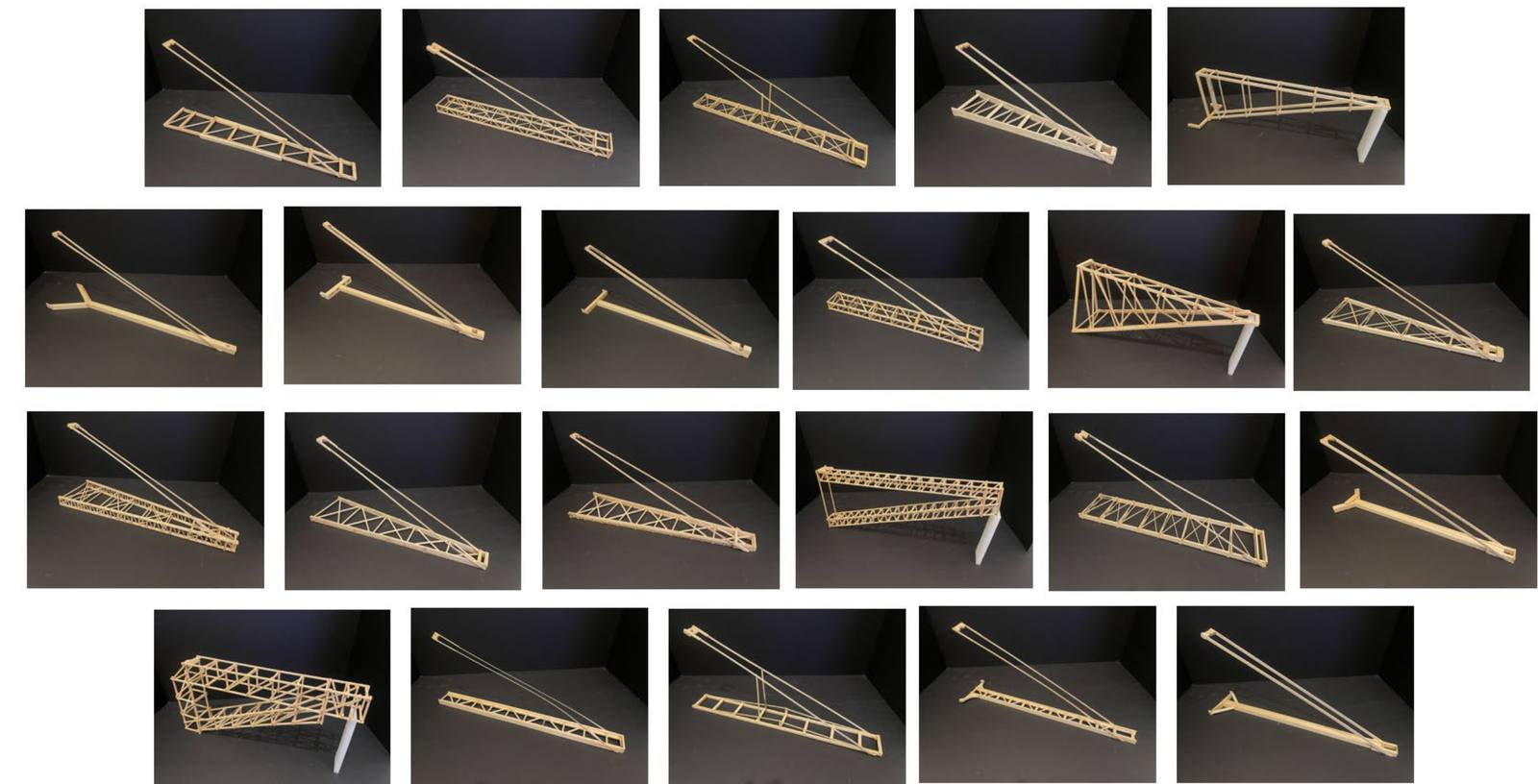Gallery of about twenty balsa and basswood boomilever designs from the 2026 season, resting on a table: ladder trusses, box trusses, tapered trusses, solid beams with T and Y feet, designs with vertical posts, and deep box-frame designs